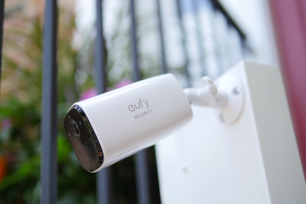  Eufy Security SoloCam E40, a white outdoor security camera mounted on a wall, designed for Motion Detector Home Security Cameras, showcasing a lens and built-in spotlight.